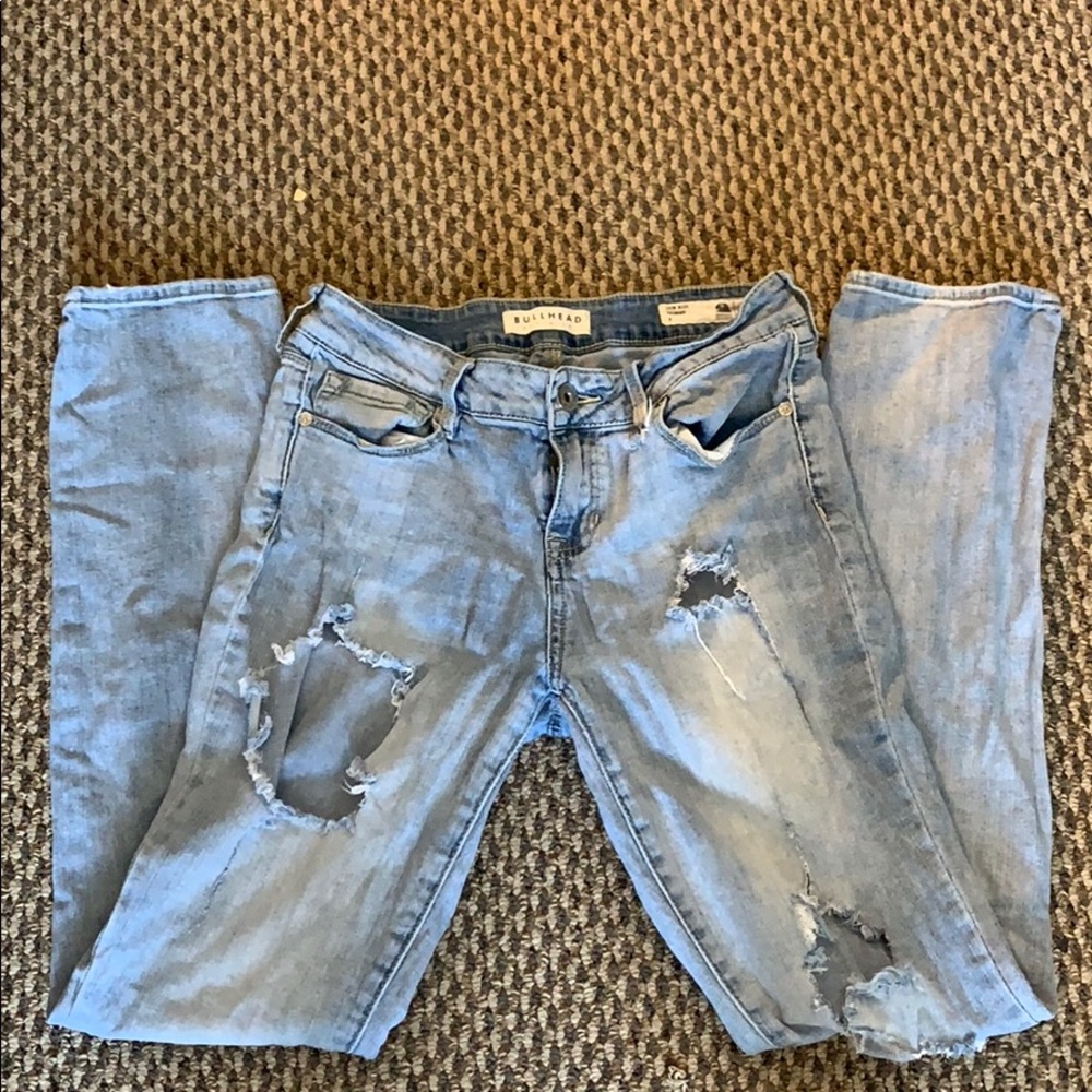 Light wash distressed jeans.